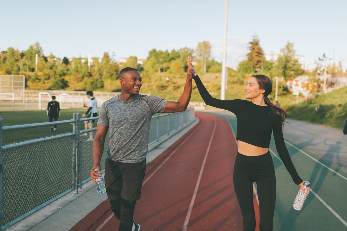 Couple Exercising in the Running Track